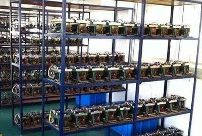 A view of a data center with numerous mining rigs inside, suggesting the scale of a typical mining farm operation.